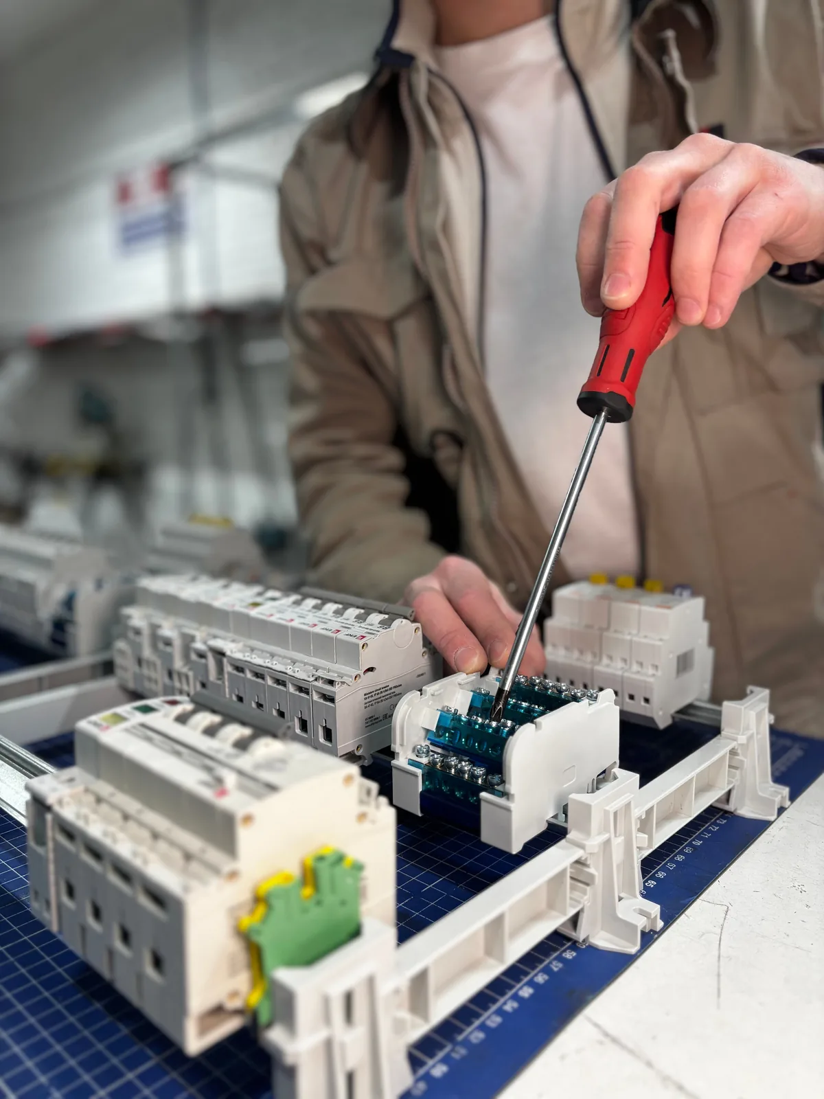Breakers assembled on a DIN rail before installation, for licensed electrician in Edmonton