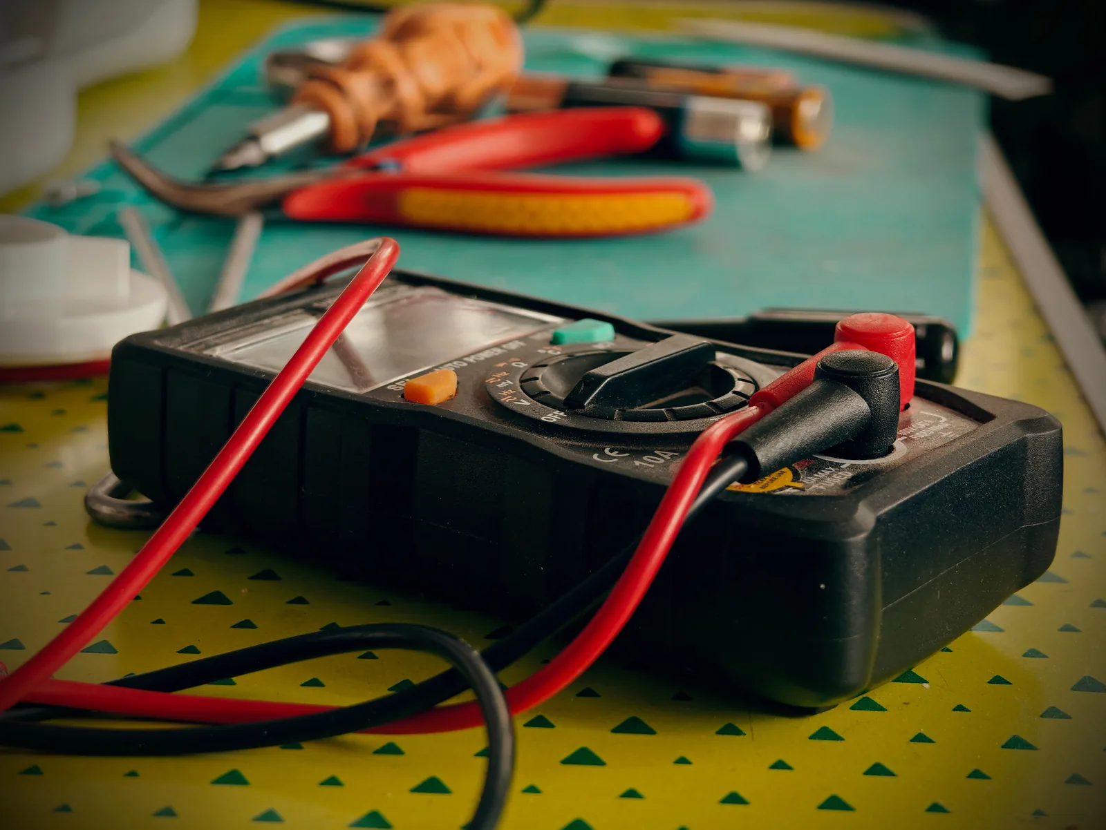A multimeter and hand tools ready for a diagnostic visit, for electrician in Edmonton
